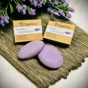 two Lavender soaps and organica packing with lavender flowers